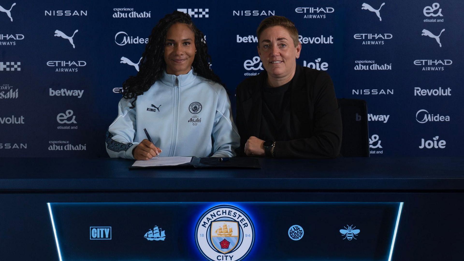 Jade Rose poses for a photo while signing her contract