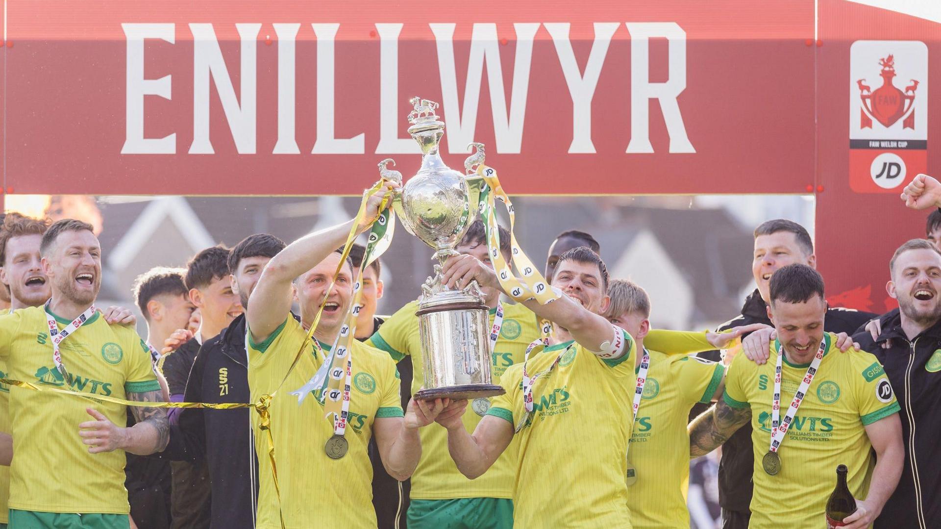 Danny Gosset and Darren Thomas lift the Welsh Cup following Caernarfon Town's win 