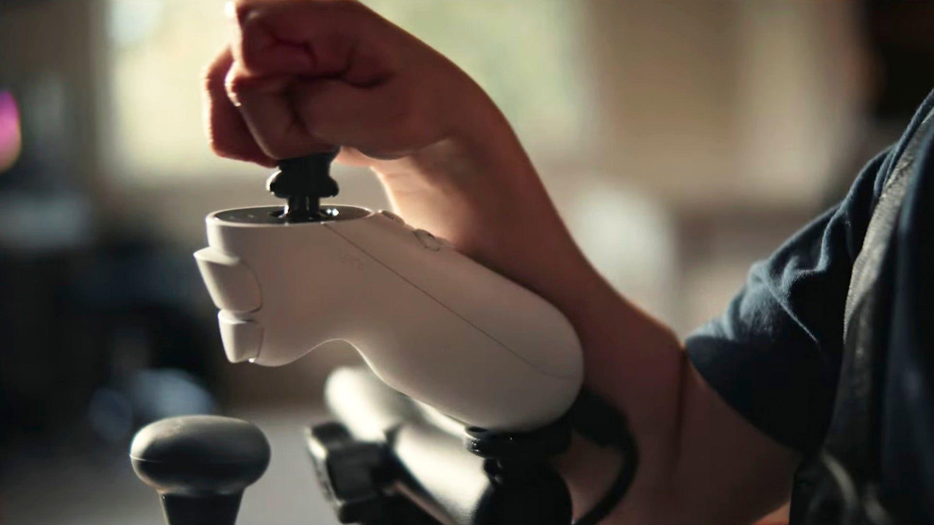 Close up of a child's hand moving a joystick controller