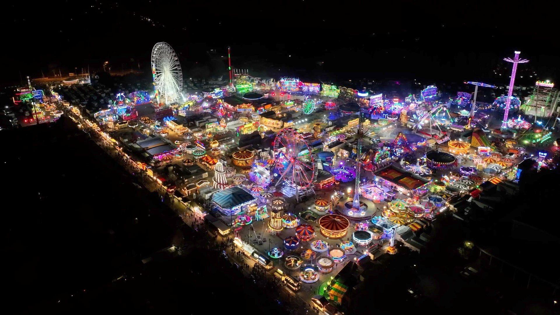 Drone footage high above Hull Fair, the footage has been taken at night and you can see the bright lights of the rides and attractions below.