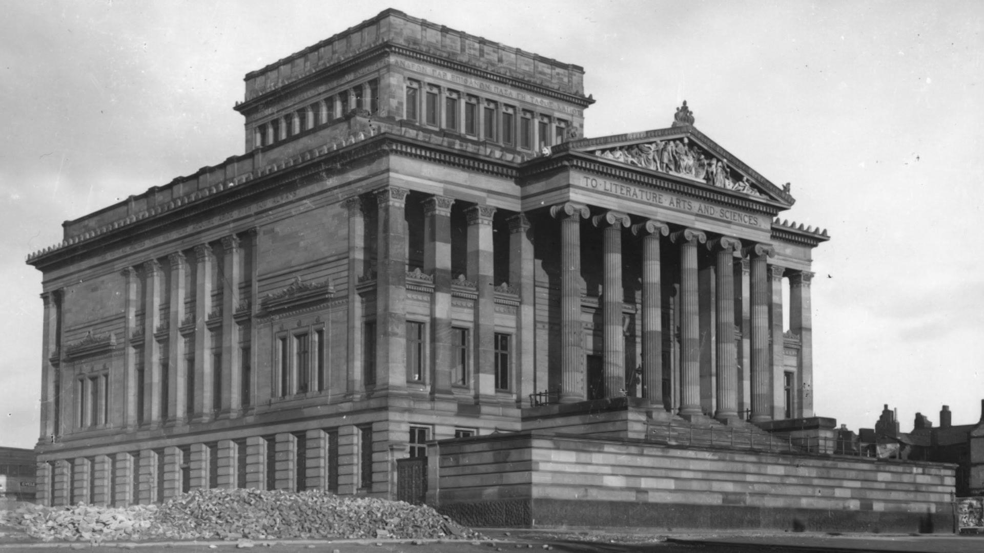 Black and white image showing the whole Harris Building with its classical column facade.