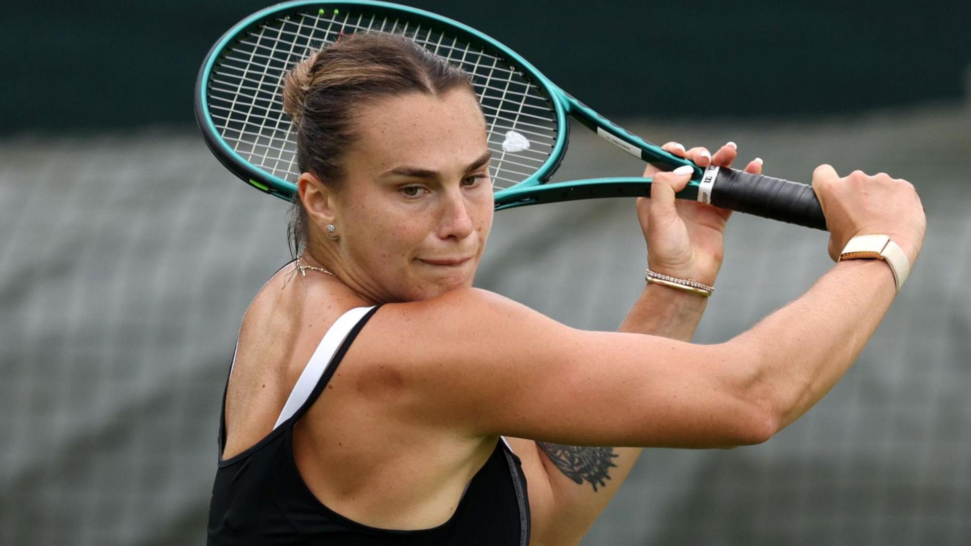 Aryna Sabalenka plays a backhand slice in practice