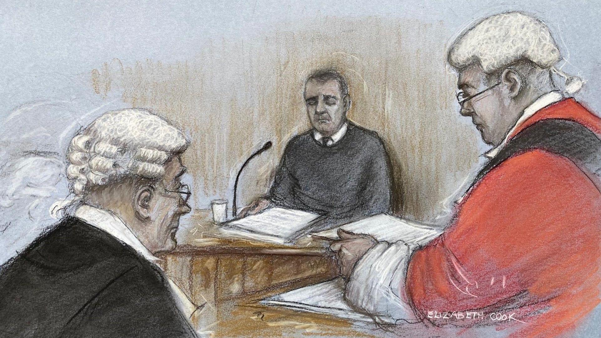 A court sketch showing John Hunt sitting in a witness box, wearing a dark-coloured jumper and tie, with a stack or folder of papers in front of him. The judge and a barrister are depicted in the foreground