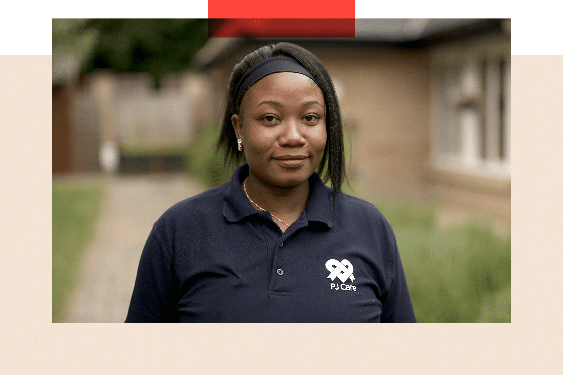 Rejoice, a woman in a blue t-shirt stands outside 