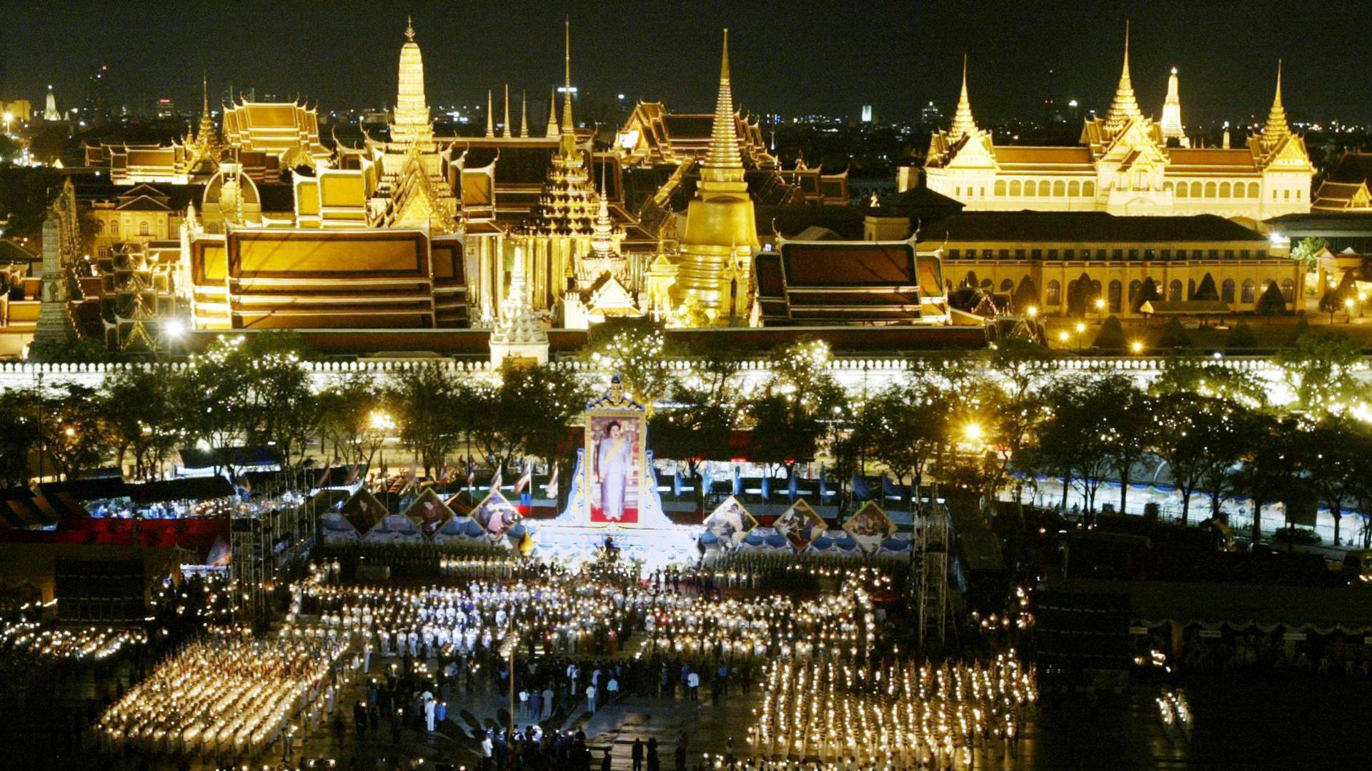 Thousands gather outside Bangkok's Grand Palace to celebrate Queen Sirikit's birthday.