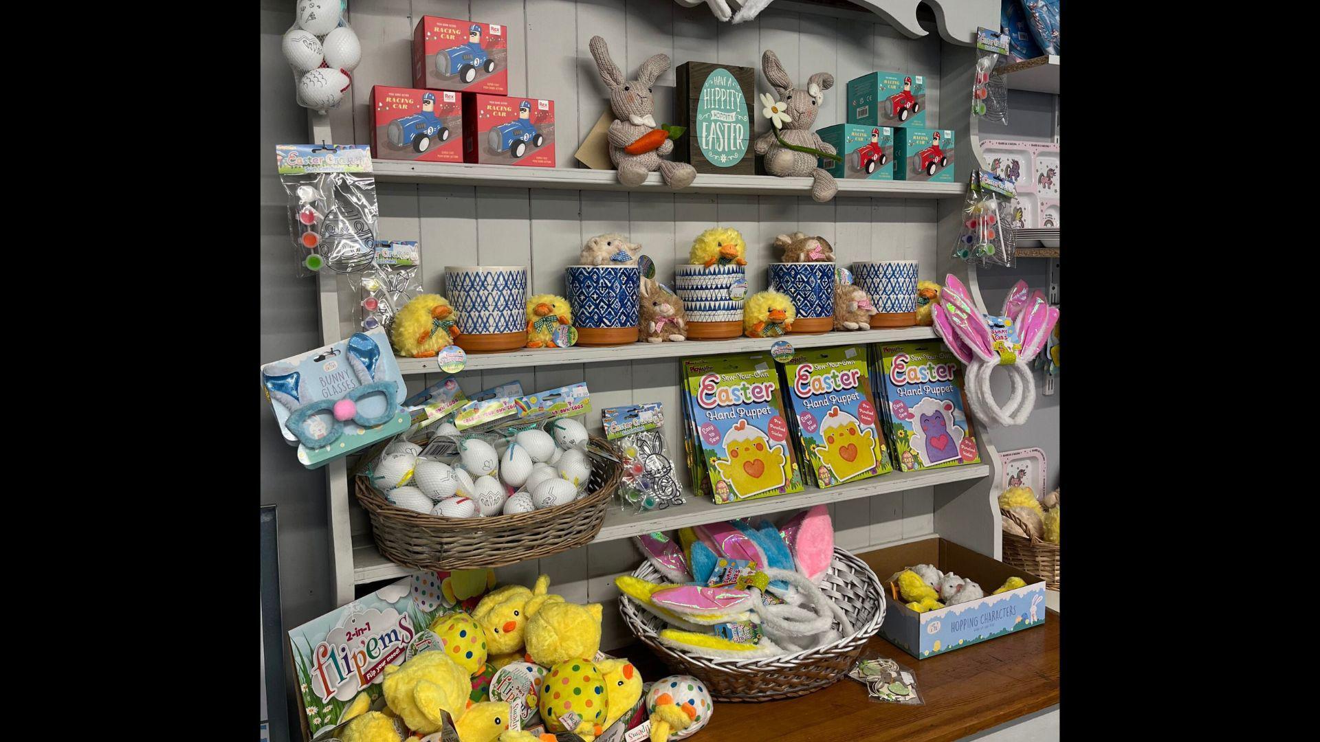 A shelf full of Easter-themed products inside a farm shop.