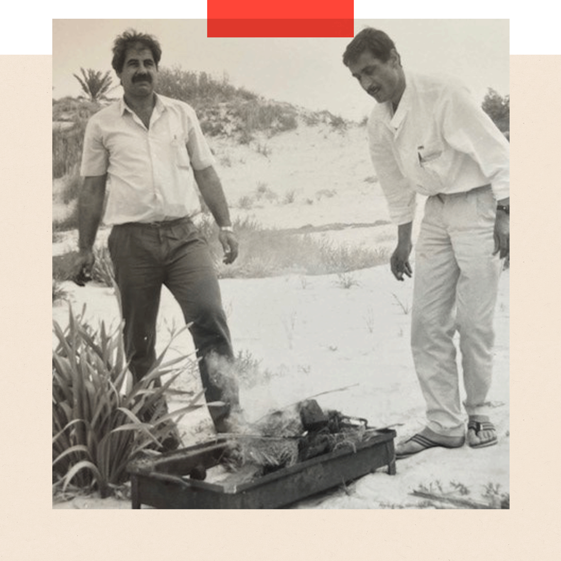 Ayish and a colleague at a beach barbecue - black and white image