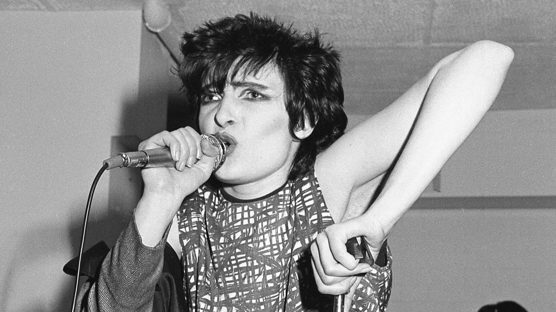 Siouxsie and the Banshees performing at The Limit club - lead singer Siouxsie Sioux singing into a microphone