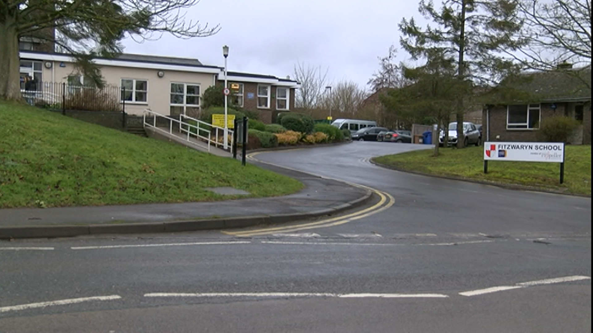 A collection of buildings with a sign in the foreground saying 'Fitzwaryn School'.