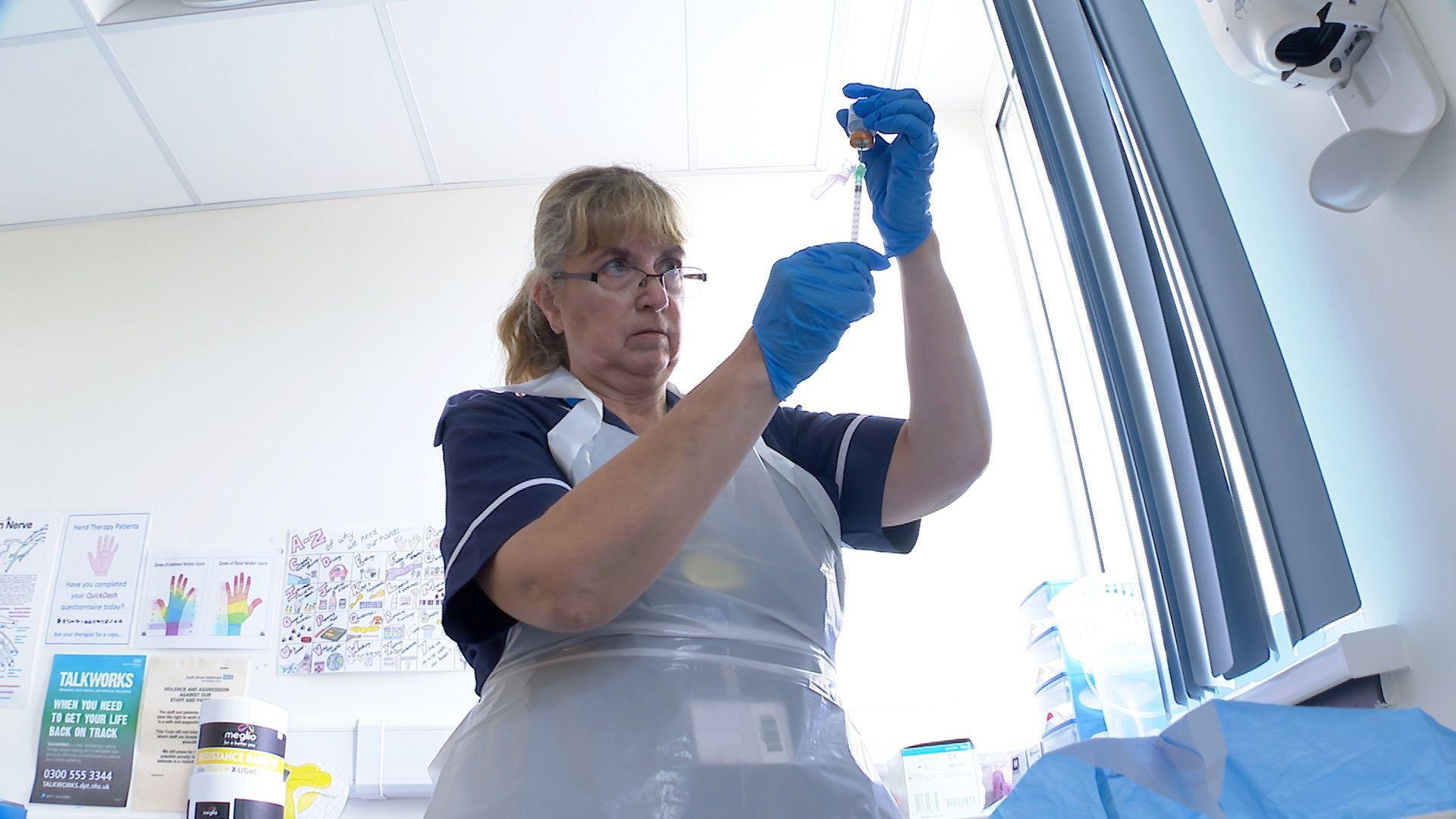 A nurse prepares a botox injection for migraine treatment