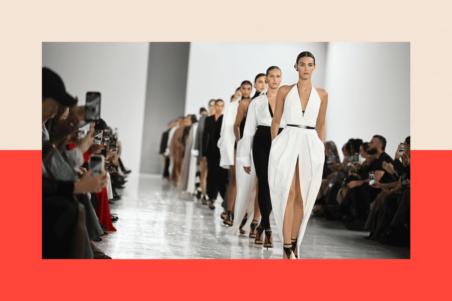 Models walk the runway wearing white and black

