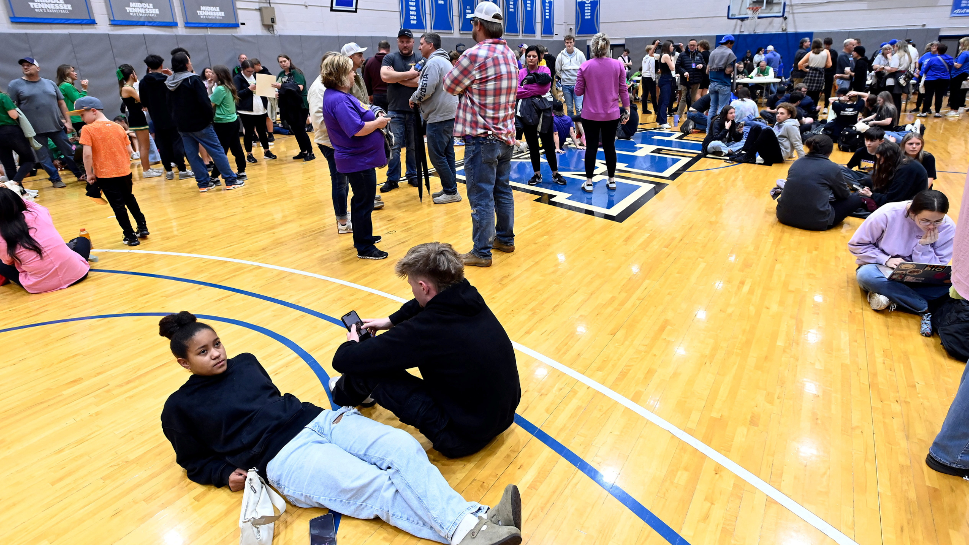 people sheltering in a gymnasium at a university in the US after tornado warnings were issued