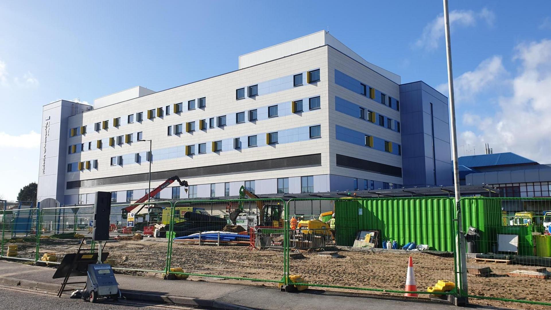 Exterior shot of the BEACH building at Bournemouth Hospital. There are road and landscaping works going on in front of the building as it nears completion.