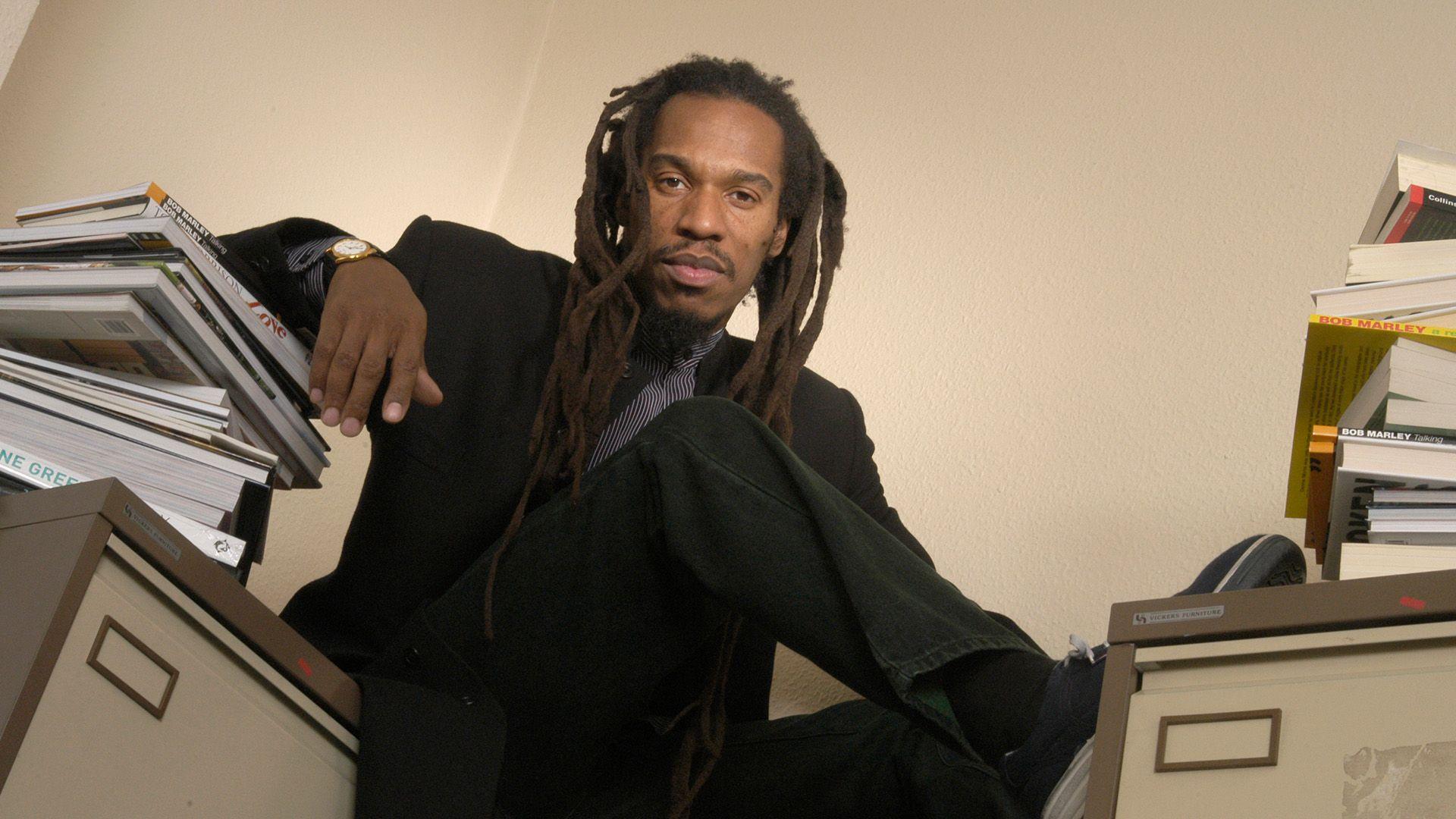 Benjamin Zephaniah surrounded by books.