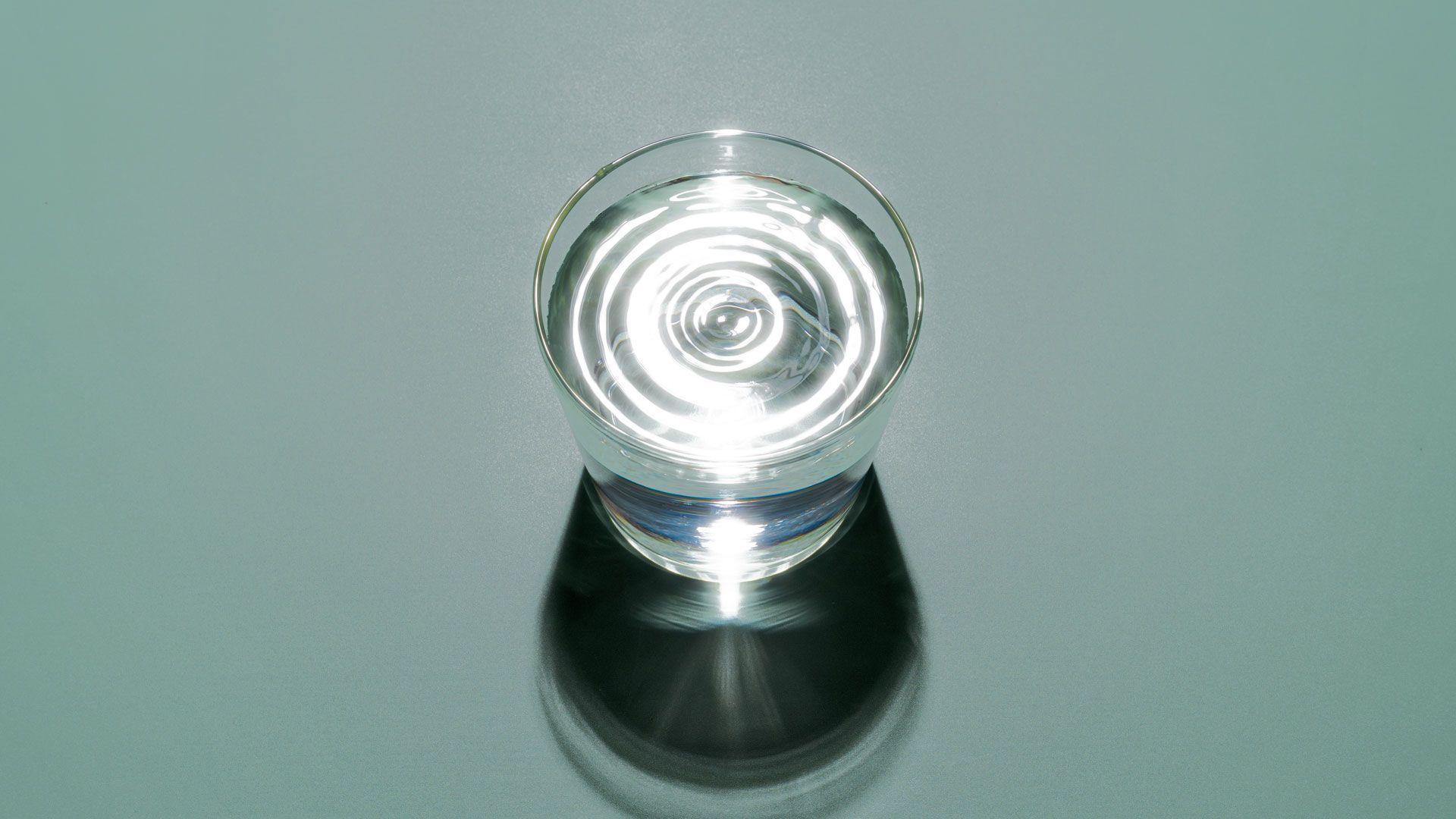 A glass of water on a duck egg background