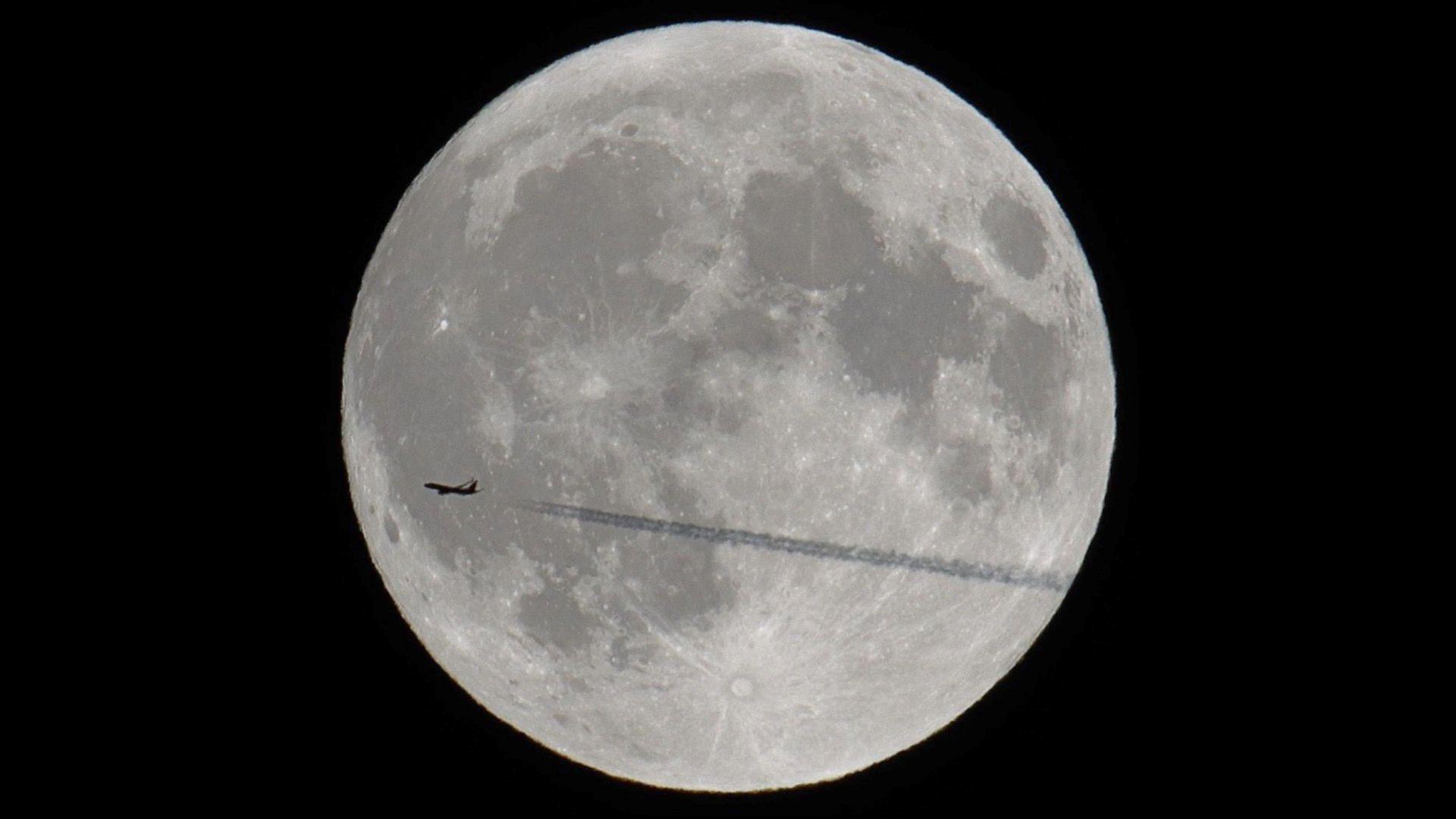 Supermoon captured with a plane flying in front of it