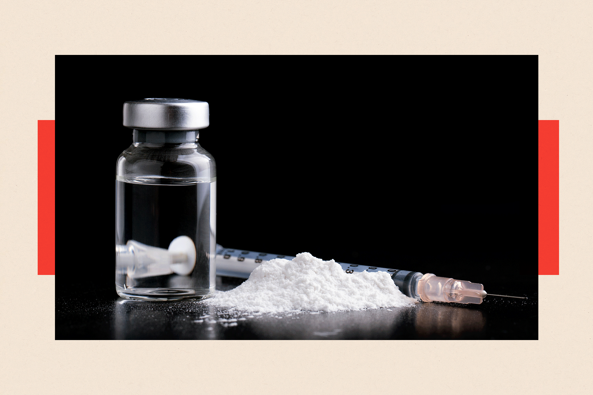 A shot of a pile of ketamine powder, with a needle behind it