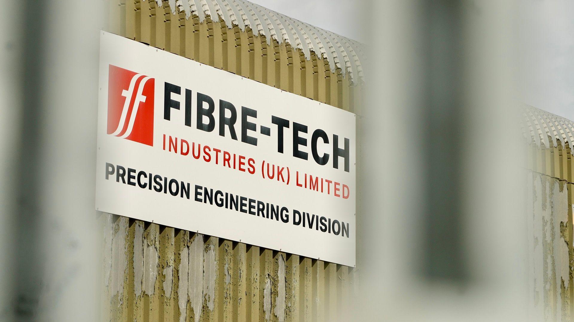 A close up shot of the Fibre-Tech sign. It says "Fibre-Tech Industries (UK) Limited" and on the next line "Precision Engineering Division".
