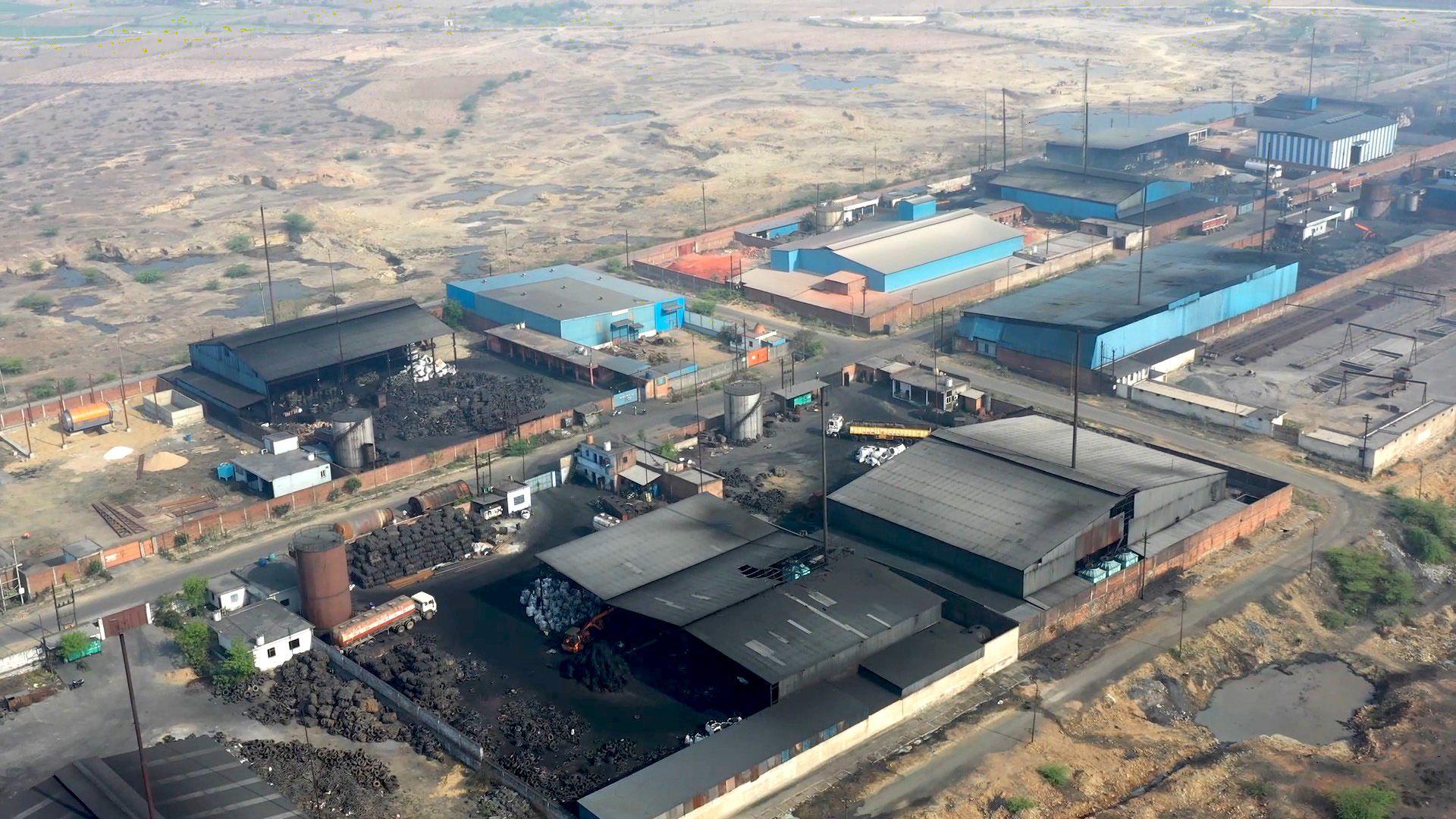 A drone shot of a cluster of pyrolysis plants against an arid landscape.