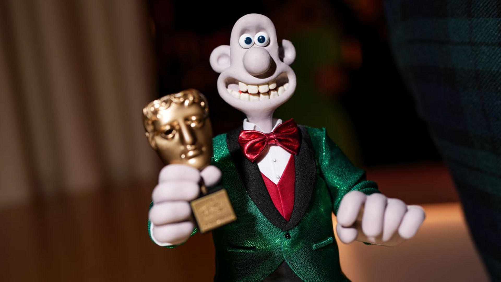 Wallace holding a Bafta