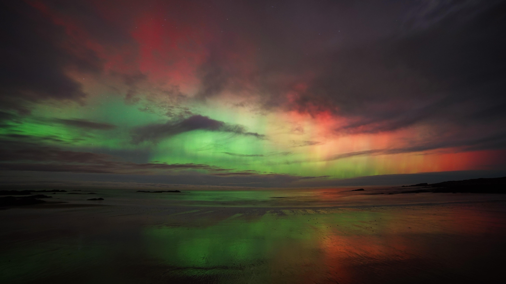Green skies amongst the clouds with hints of red and yellow too, the photo was taken in Hopeman, Moray