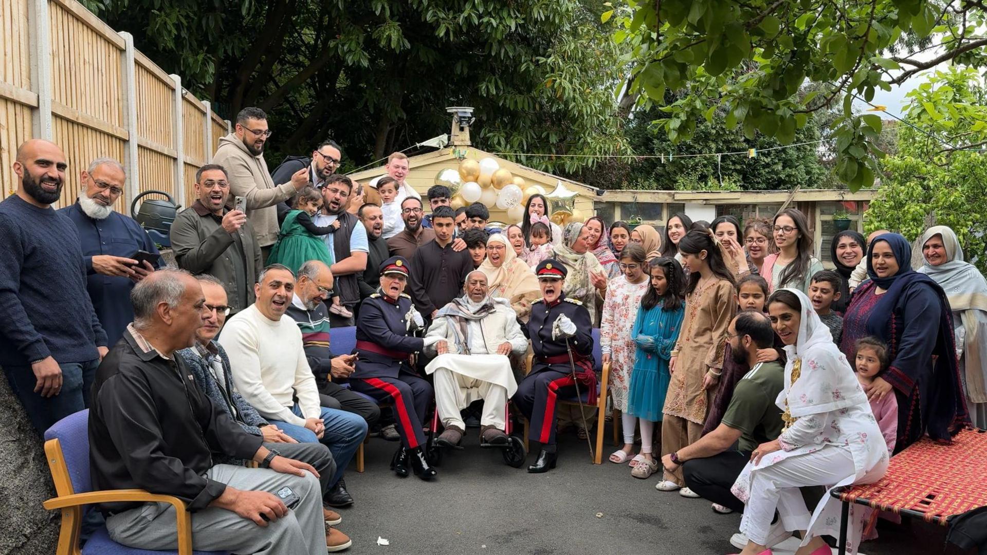 Mirza Khan celebrating his 103rd birthday with his family, which includes his six children, 21 grandchildren and 24 great grandchildren.