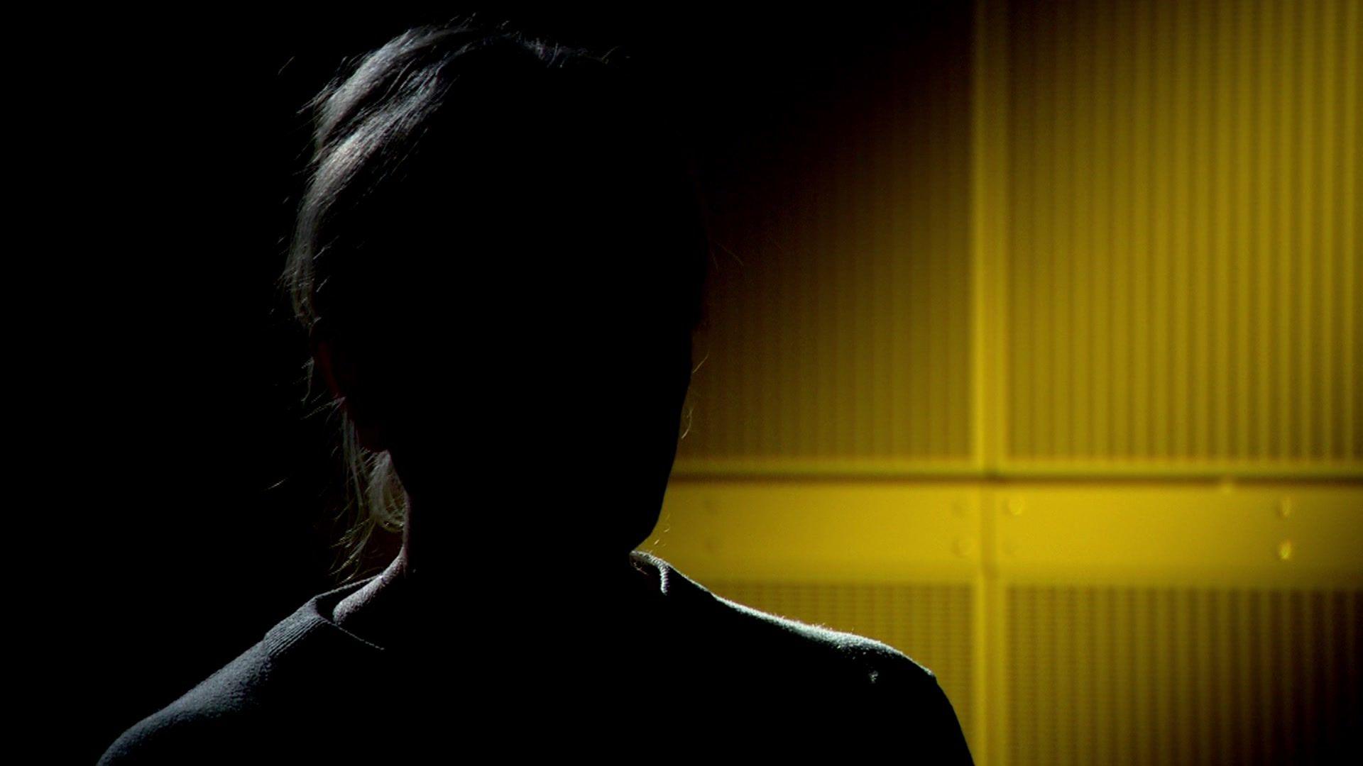 A silhouette of 'Lorraine', who is speaking to us anonymously.