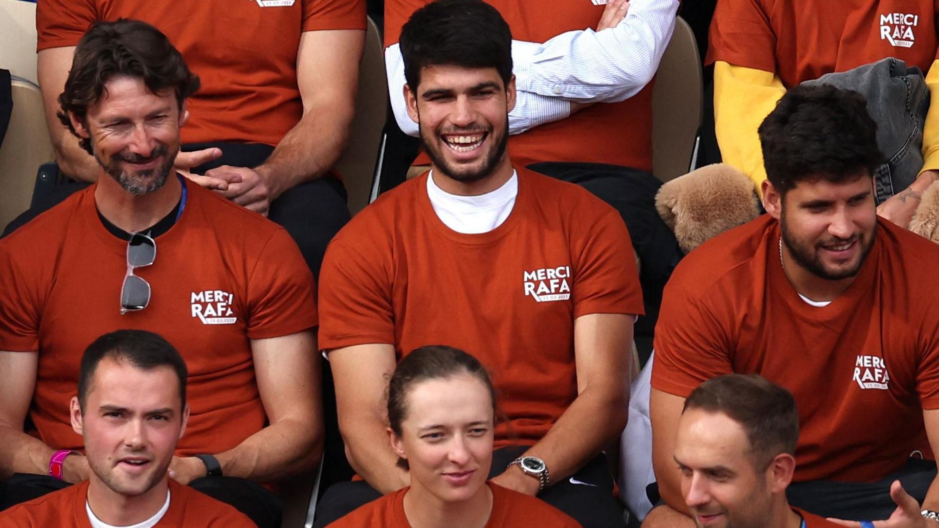 Reigning French Open champions Carlos Alcaraz and Iga Swiatek watch the ceremony