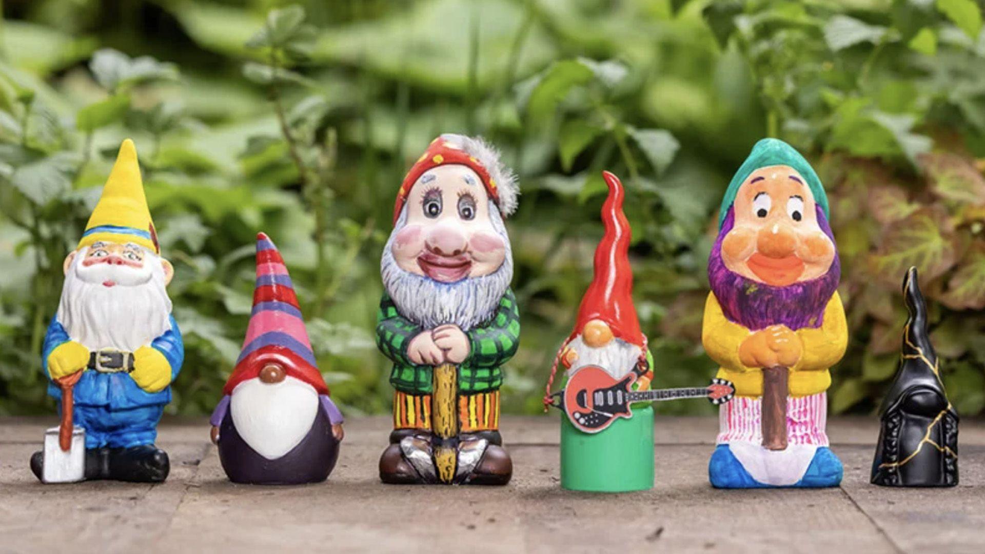 six colourefully painted gnomes stand in a row