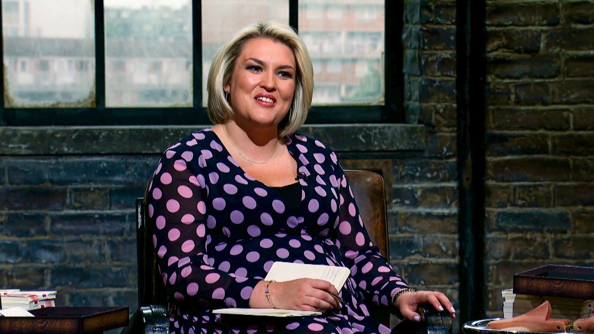 Sara Davies sat down on the set of Dragons' Den wearing a black dress with purple spots