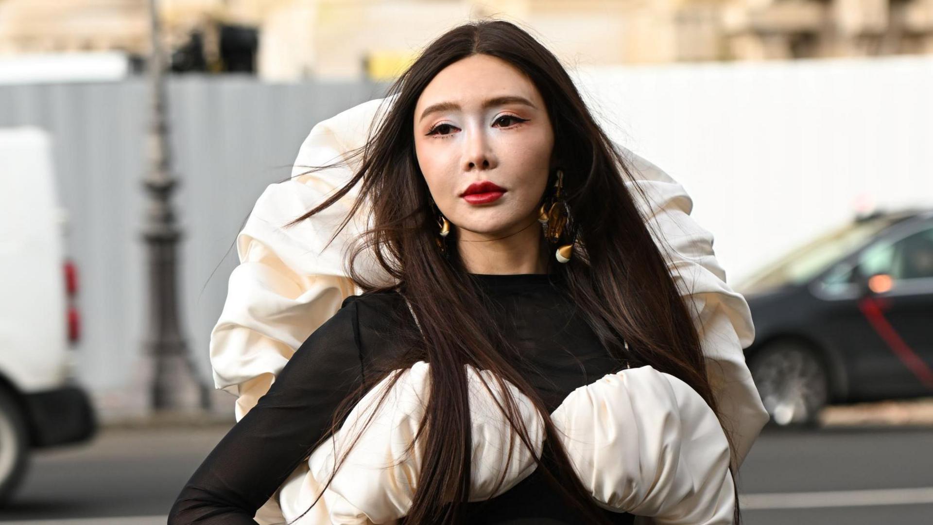 Shafira Huang, a young lady of Asian appearance, wearing a black and white Elsa Schiaparelli outfit