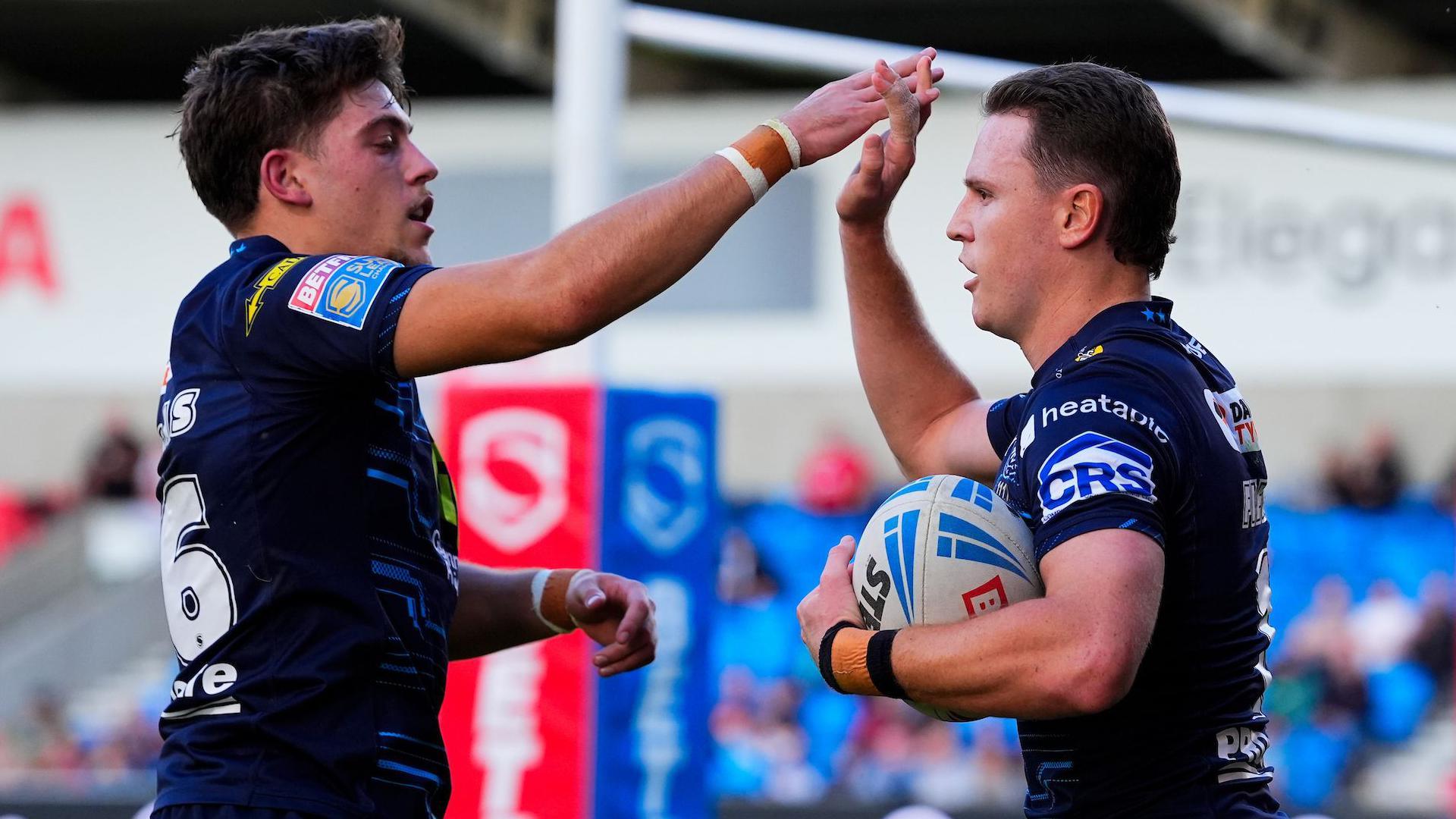 Jacob Douglas (left) and Jai Field (right) celebrate for Wigan Warriors