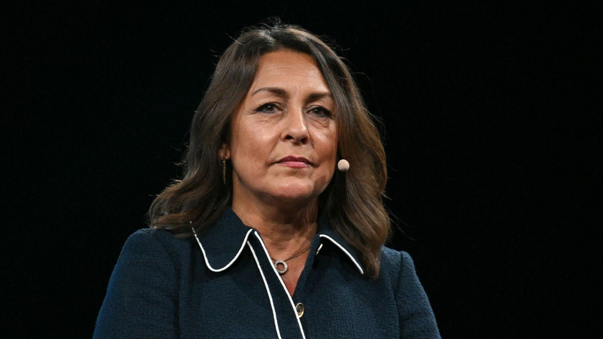Kent County Council leader Linden Kemkaren. She has long brown hair and is wearing a dark blue jacket.