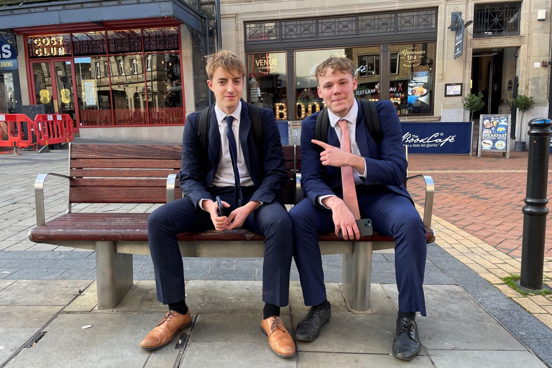 Alfie Grimwood and Aidan Pettitt sitting on a bench