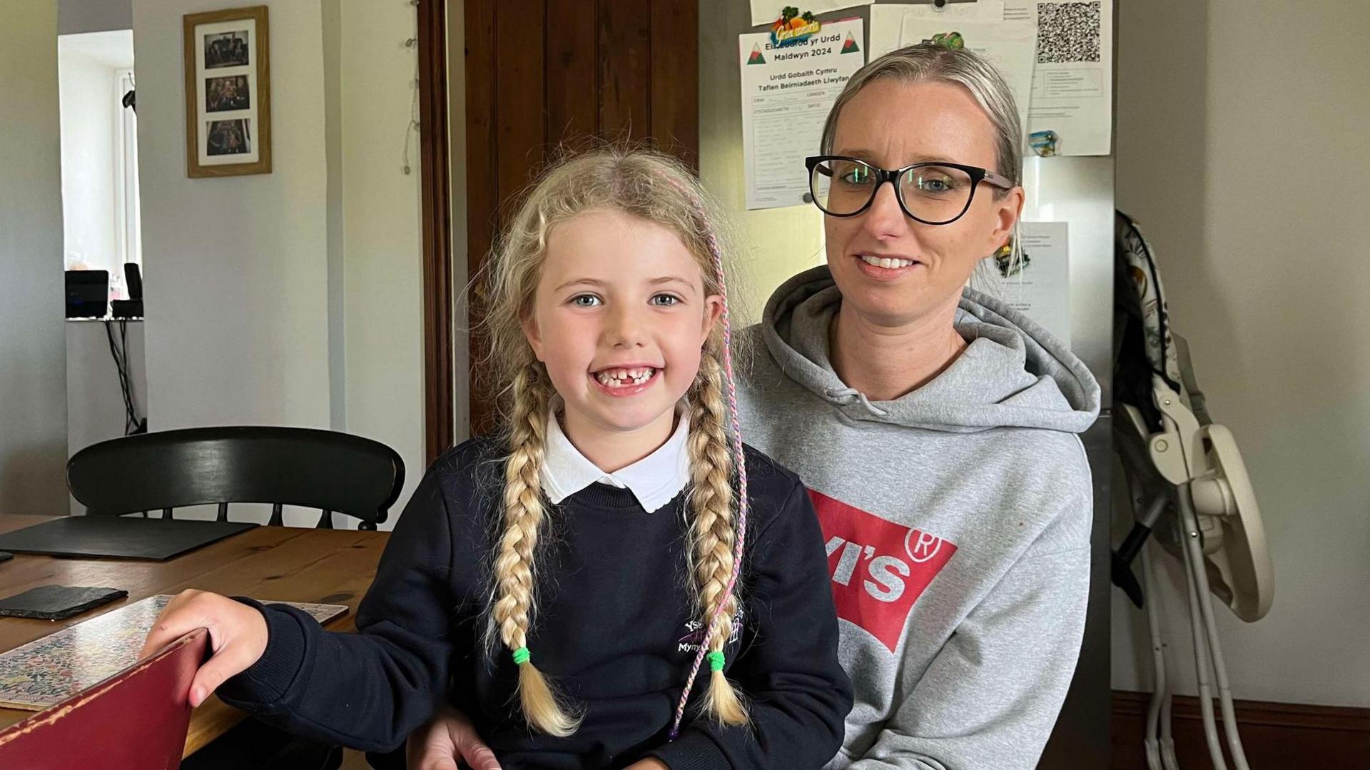 Nanw with her mum, Ffion, after her return to school