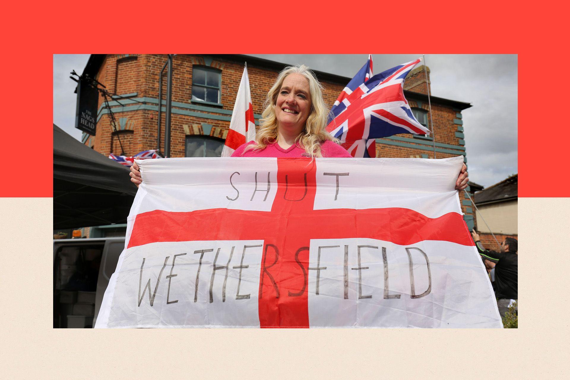 A woman holds an English flag with the words 'Shut Wethersfield' written on it