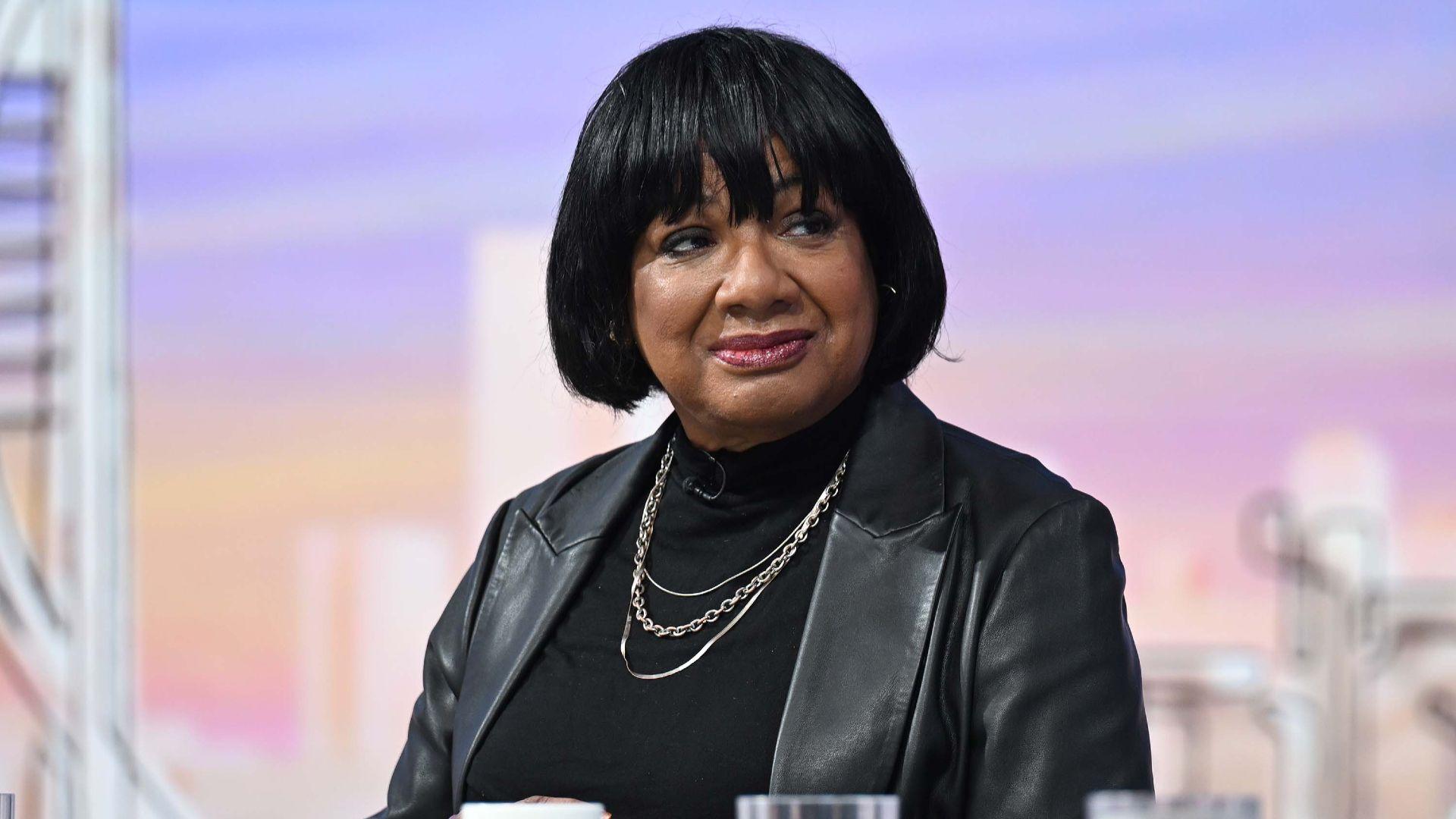 Diane Abbott is wearing a black leather jacket.