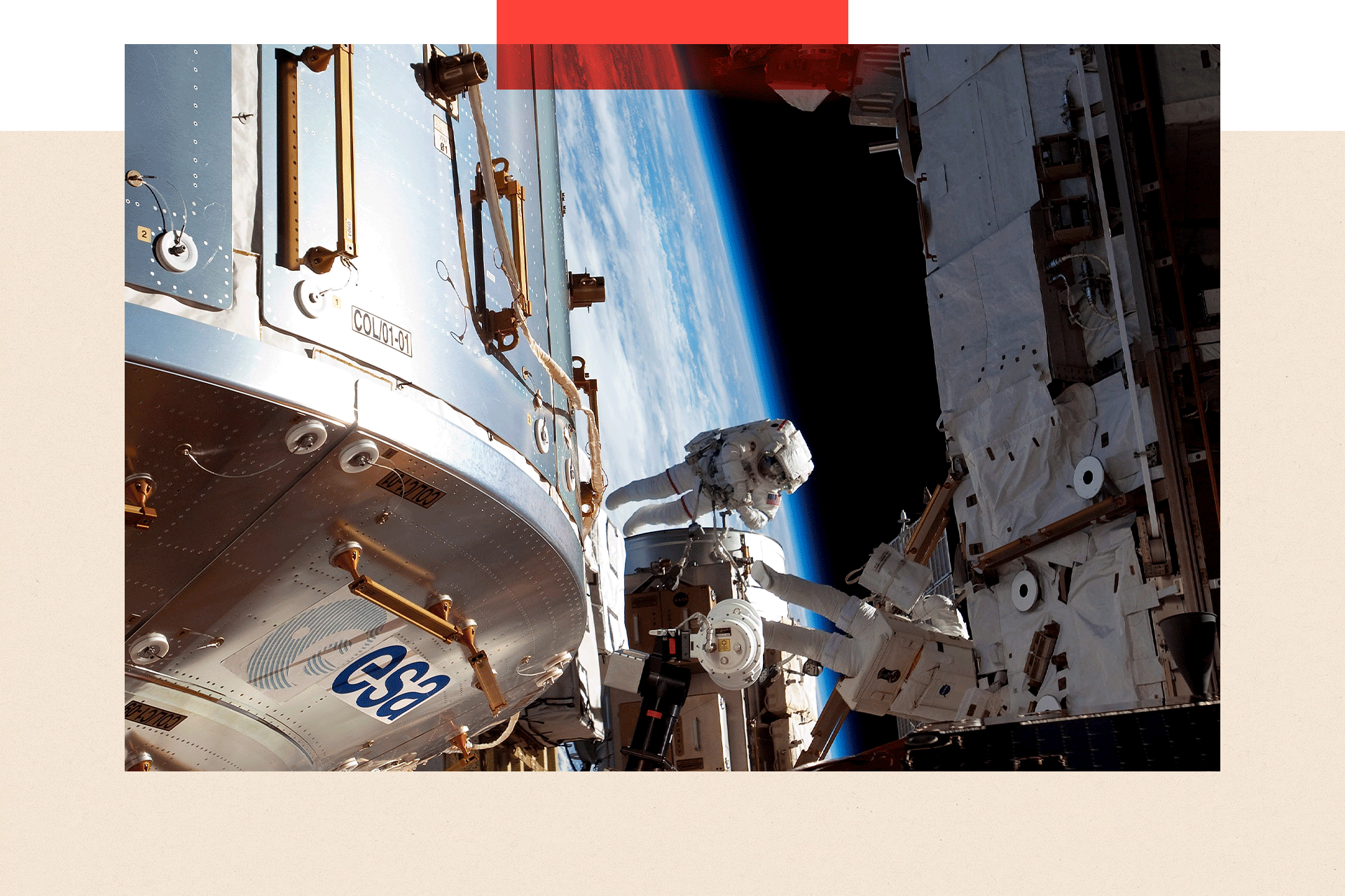 Two astronauts do some maintenance on space equipment with Earth in the background