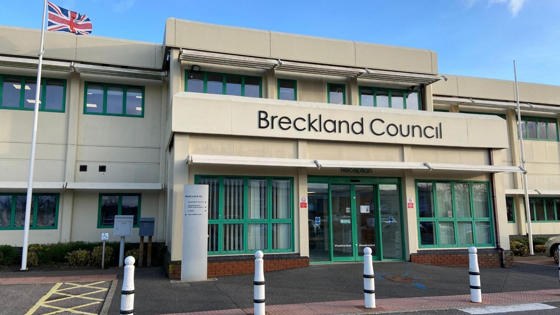 Breckland Council building main entrance. A Union Jack is hoisted on a flag pole outside the building