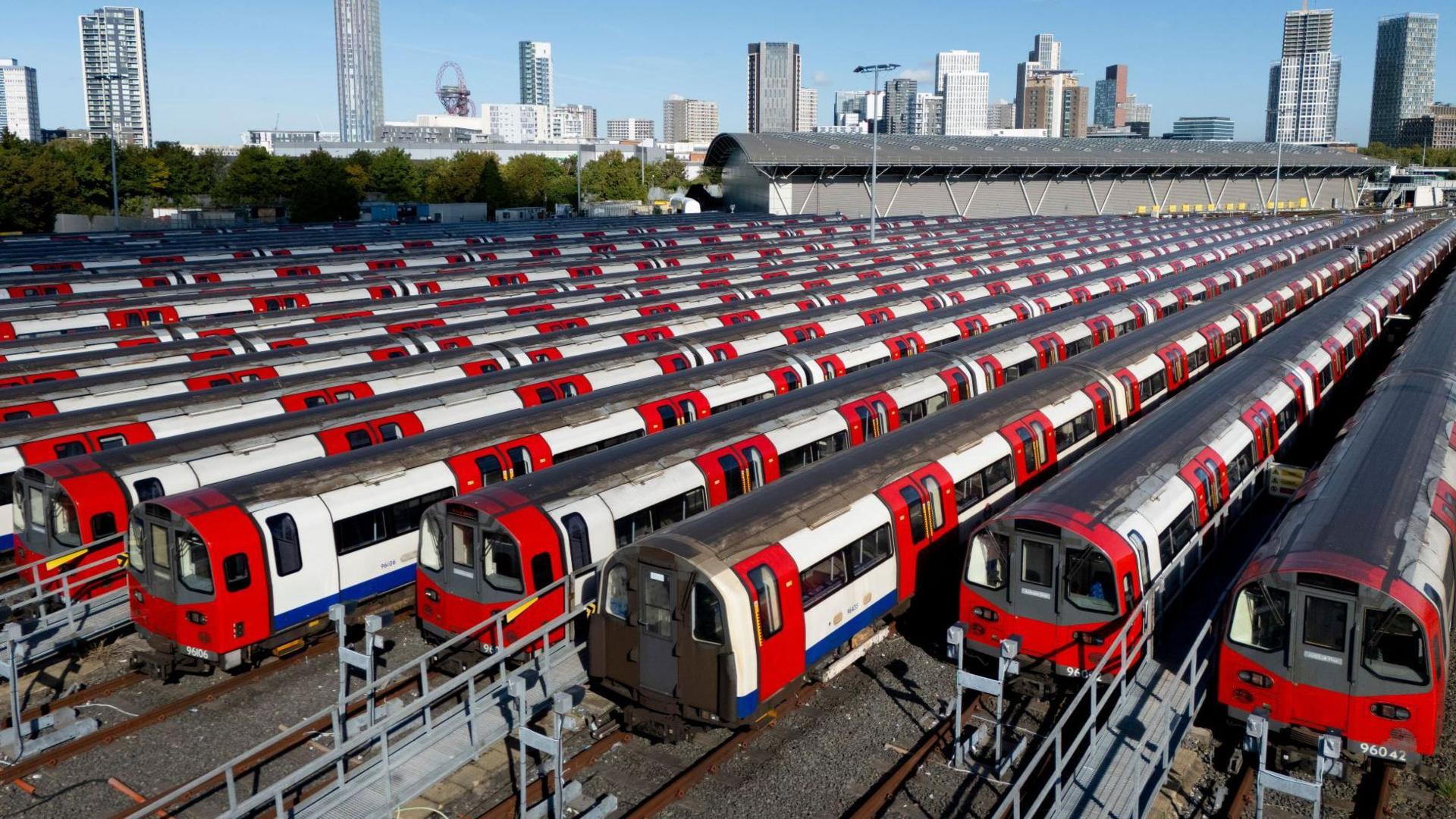 An aerial view of several Tube trains stationary, parked at a depot.