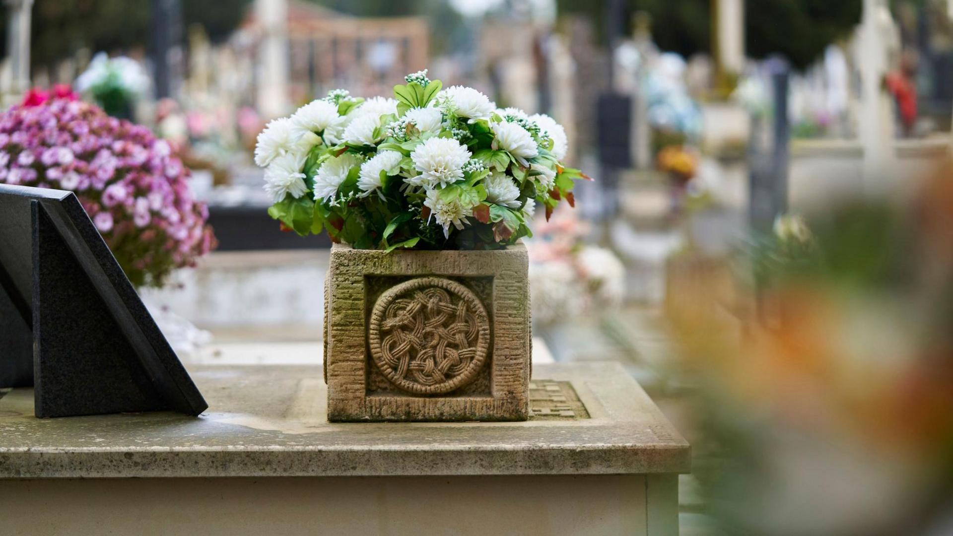 Basket of flowers at a cemetery.