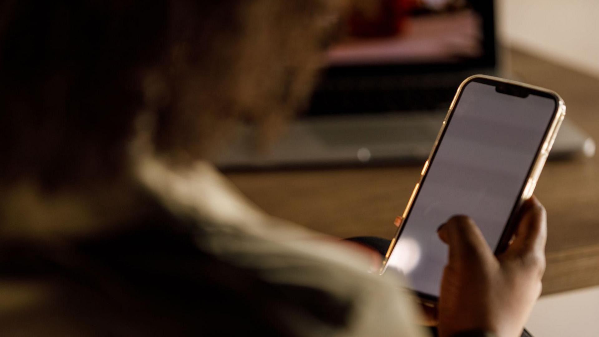 A stock image of a woman using a mobile