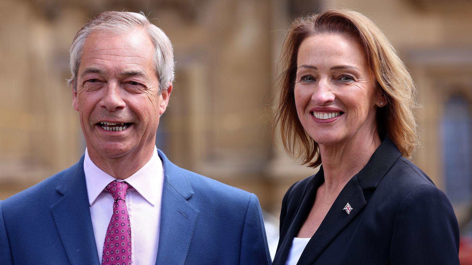 Nigel Farage (left) smiles as he stands next to a smiling Pochin with the backdrop of parliament behind them, both wearing suits, in Westminster in May.