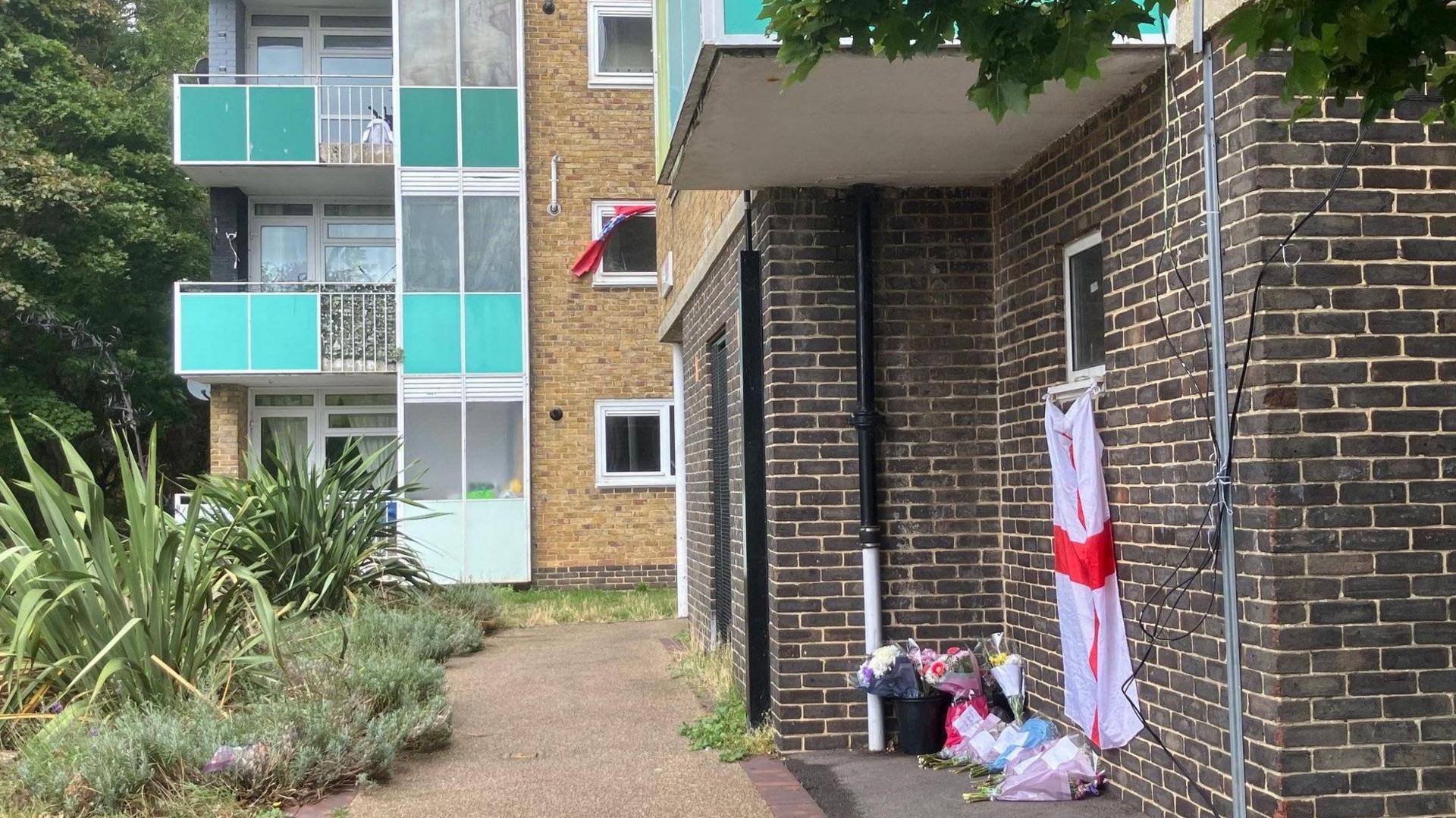 Bouquets of flowers left in front of the block of flats.