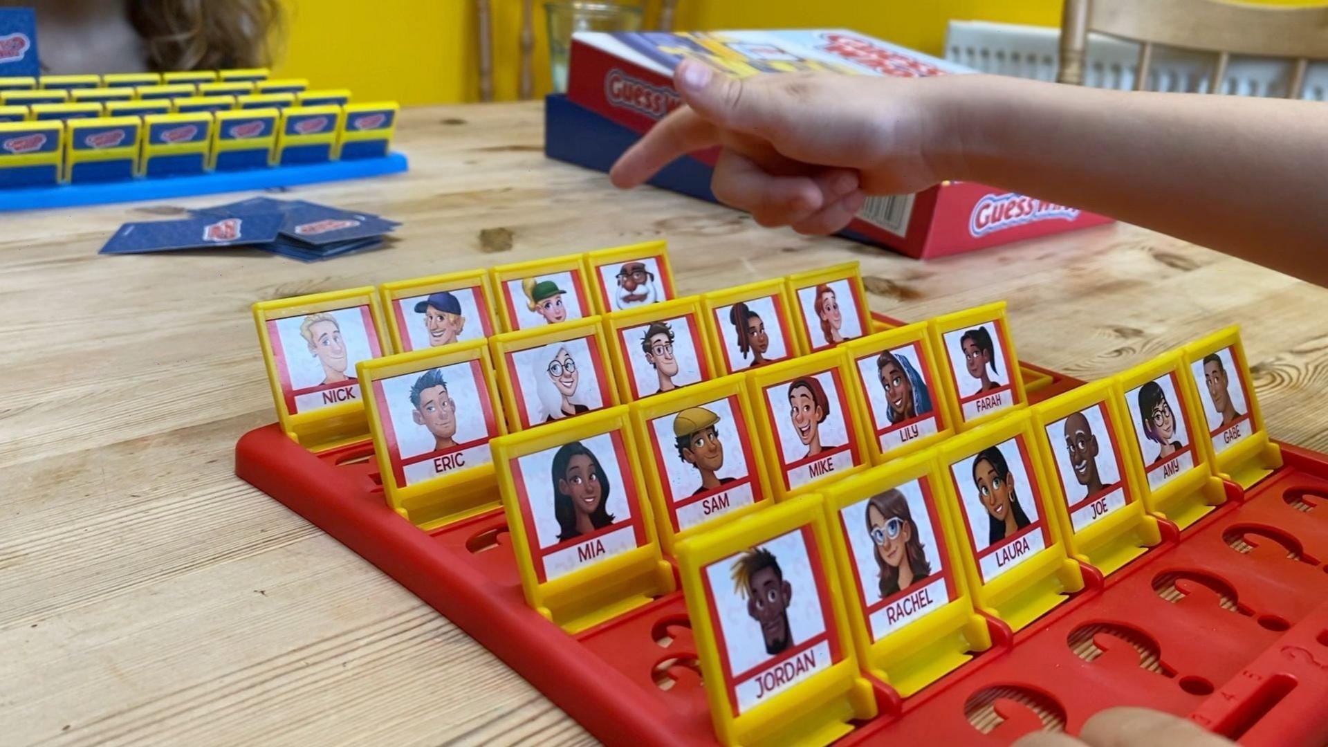 Two children playing Guess Who?