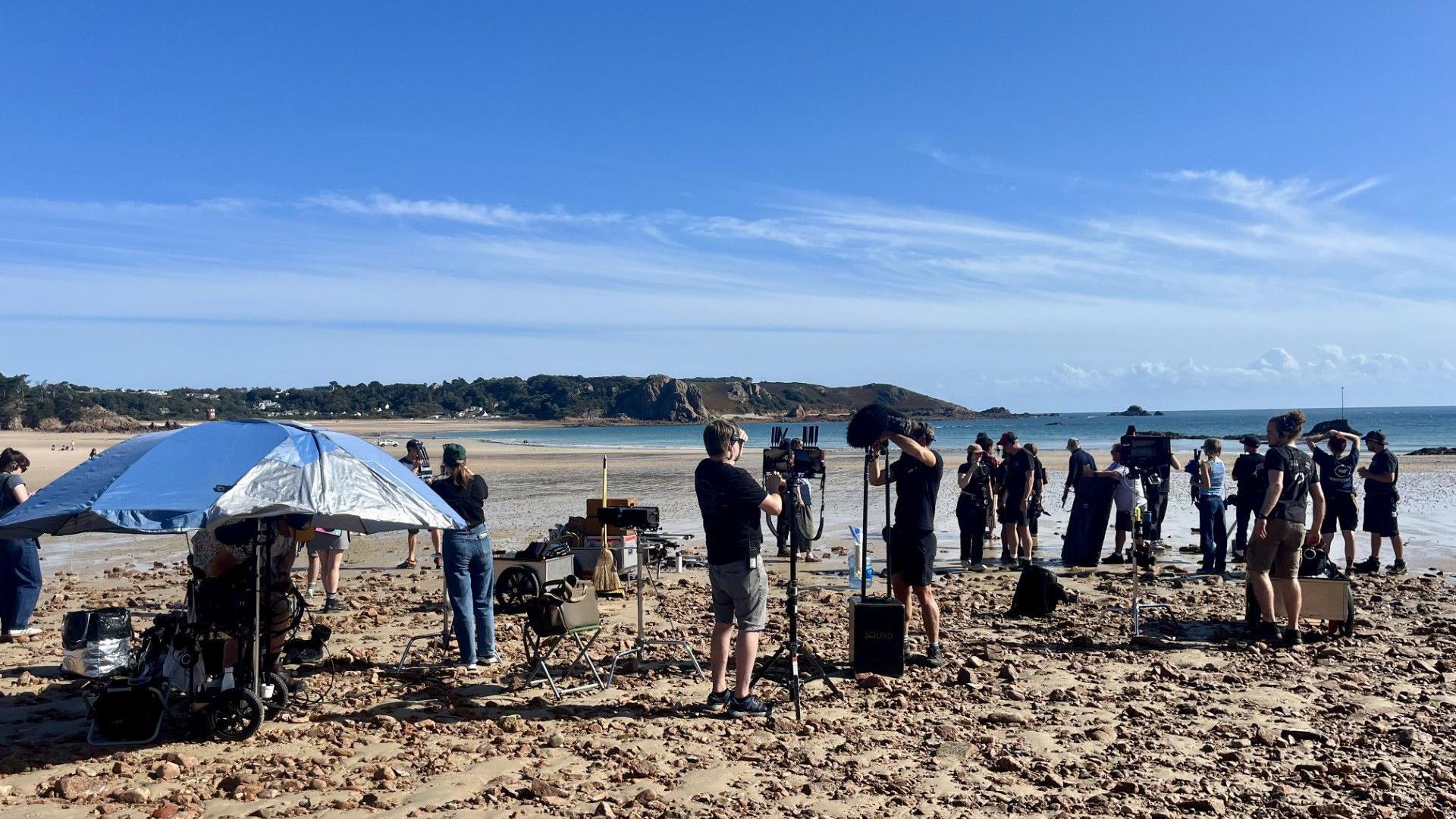 camera crew on beach set filming 