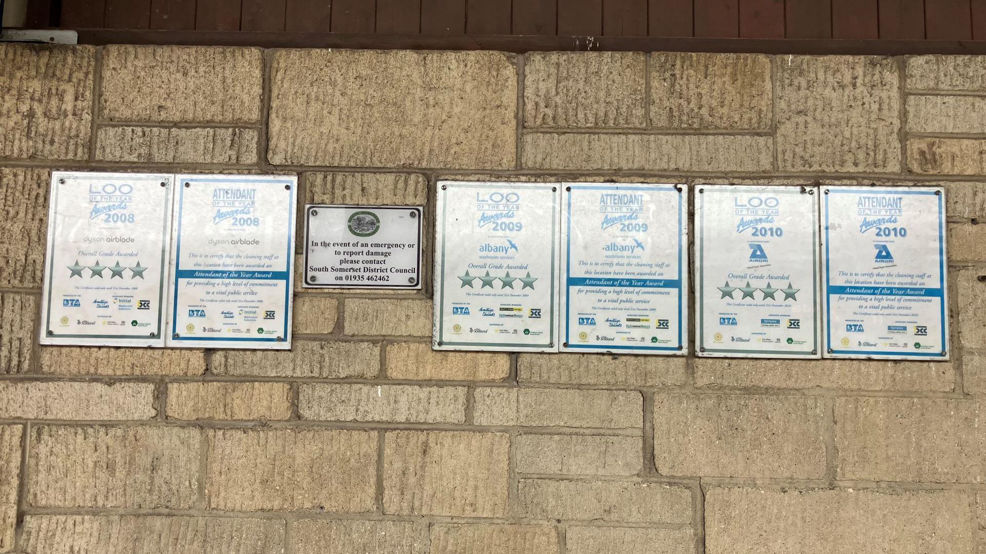 Awards on the wall of the toilets