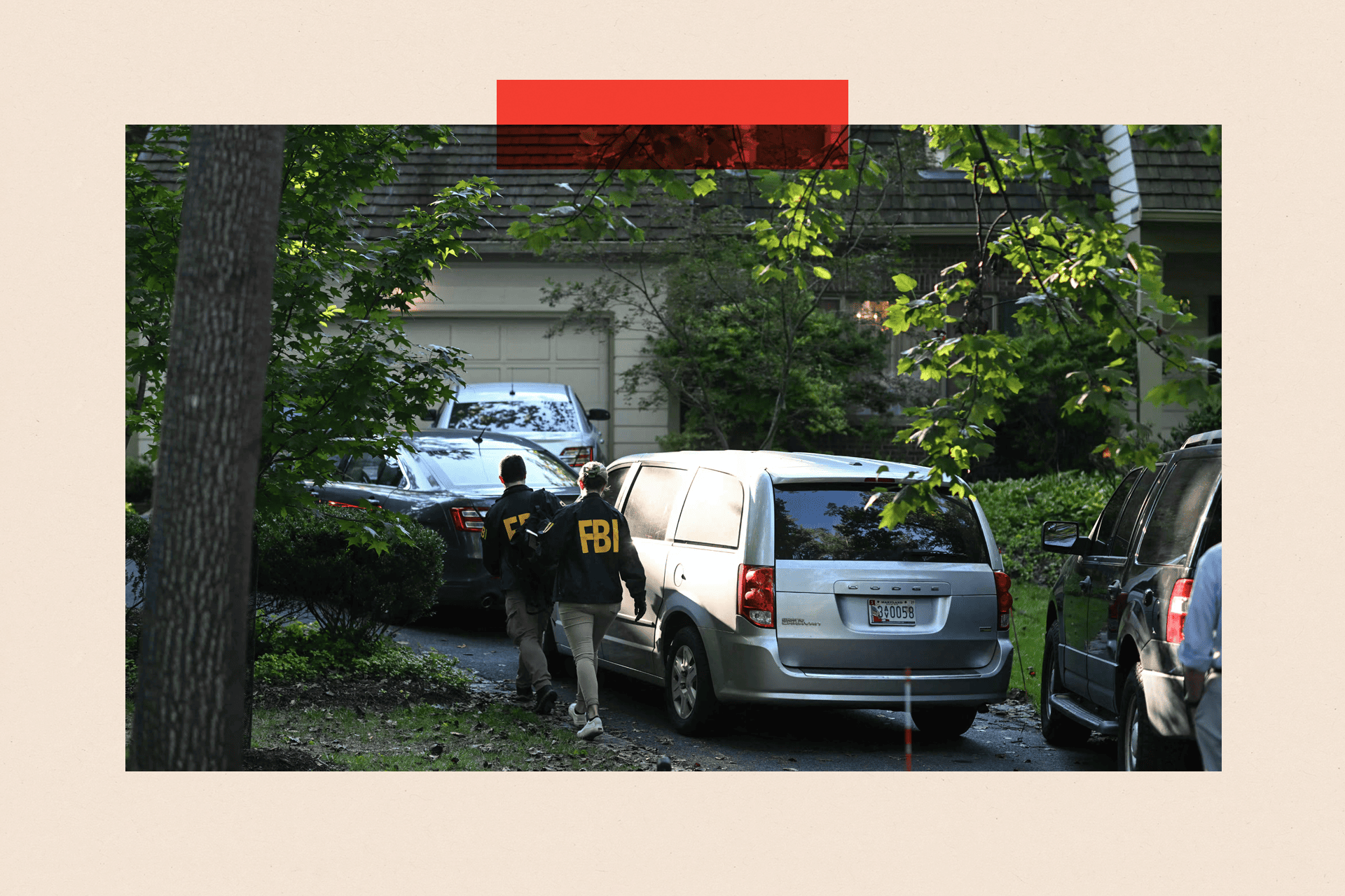 People in FBI jackets walk up the driveway of a house