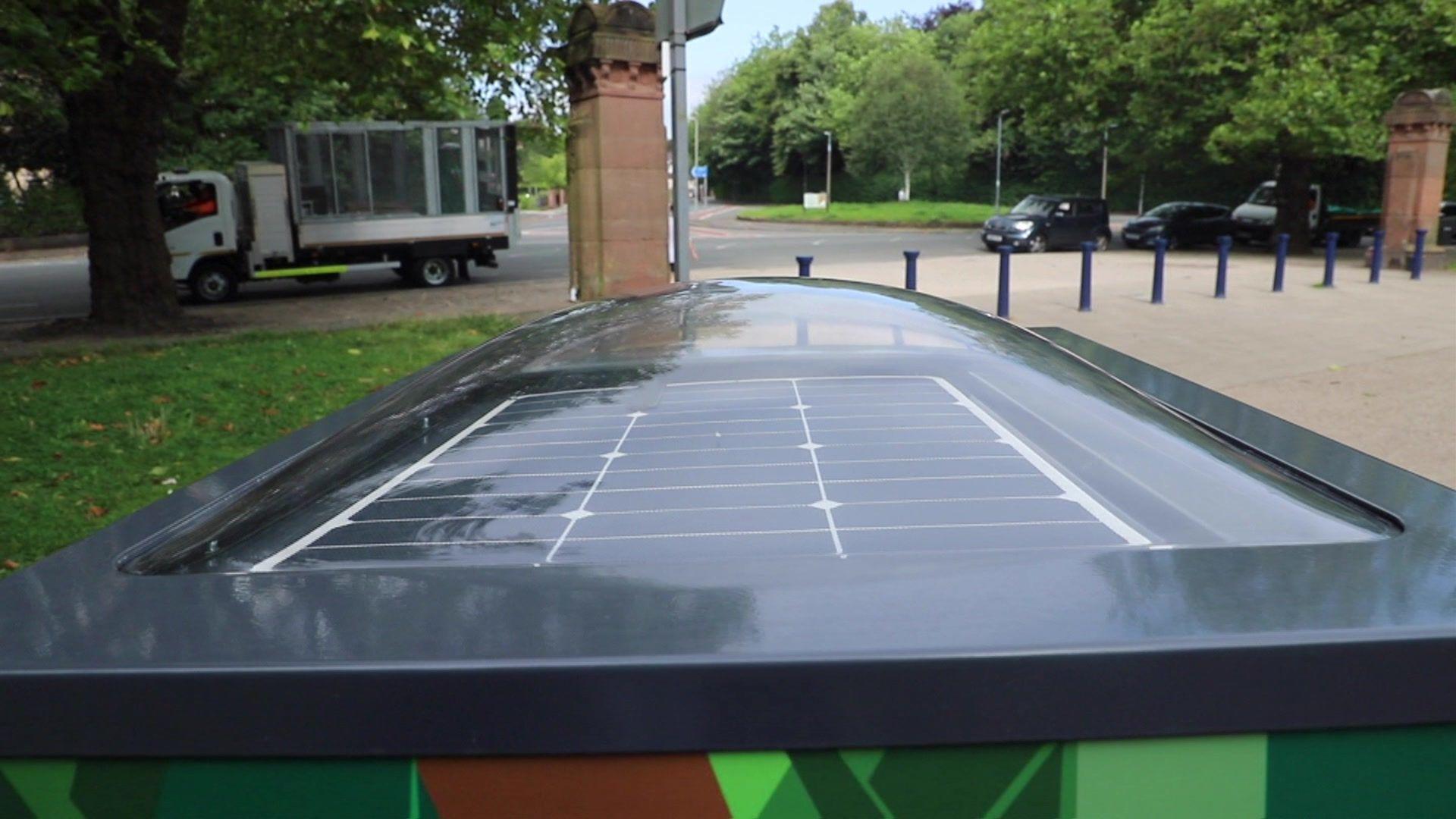 The black solar panel protected by a Perspex dome on top of one of the bins being trialled in Liverpool