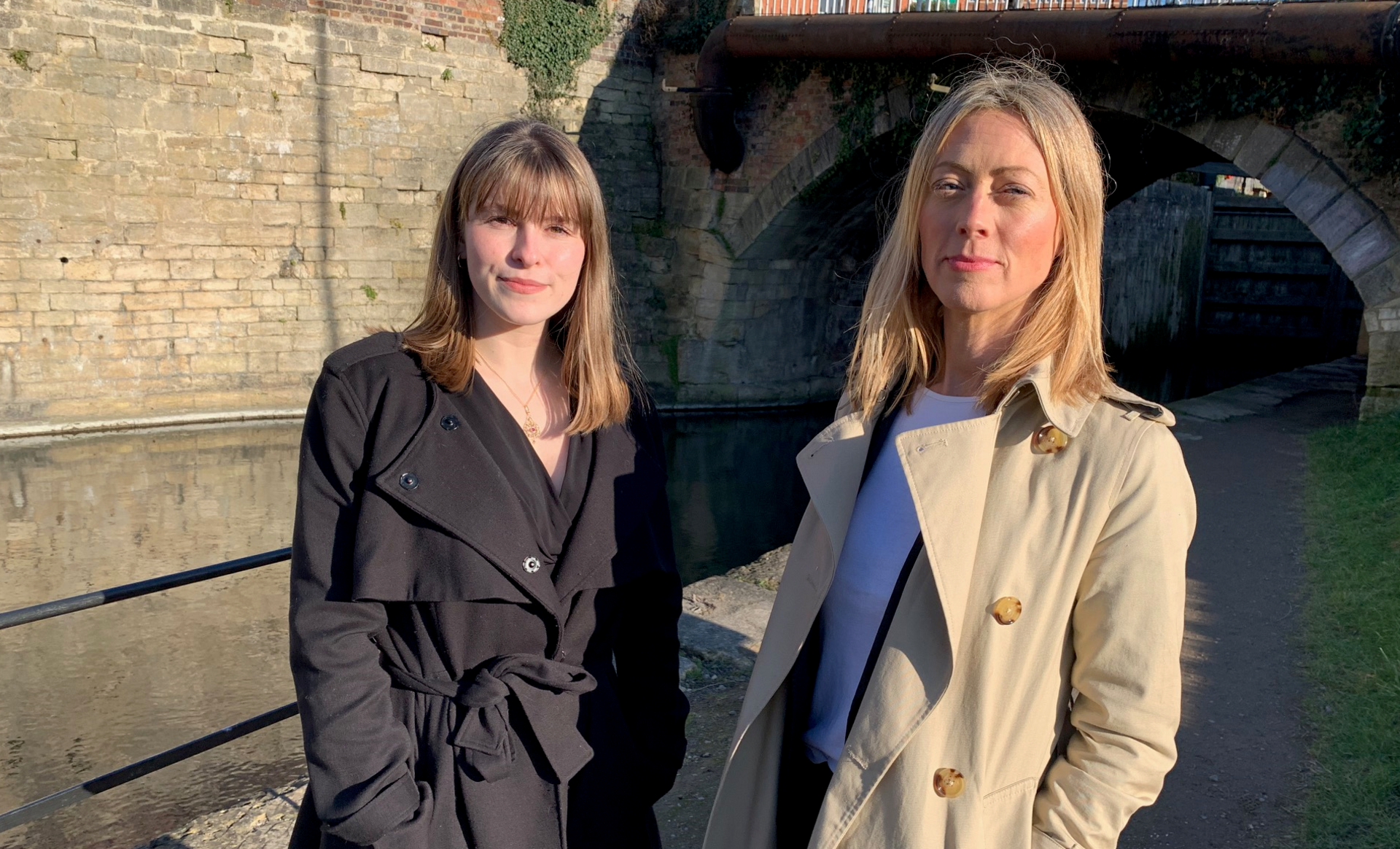 Two women stood in front of a canal